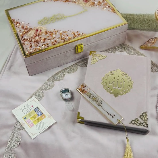 Misty Rose Barkat-e-Jariyah resin Quran hamper, luxury Islamic prayer essentials gift set including velvet Quran, handmade prayer mat, resin rehal, tasbih, bookmark, and personalized velvet box.