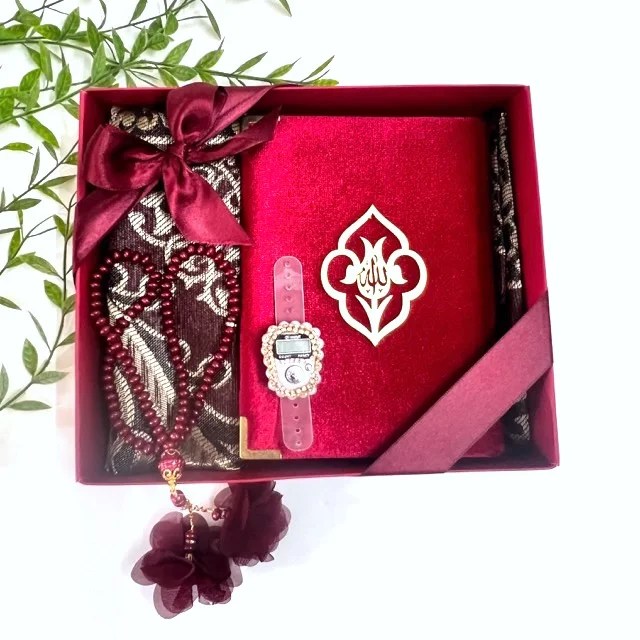 Elegant Red Islamic gift hamper featuring velvet Quran box and Turkish prayer rug.