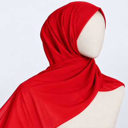 A bright red hijab draped on a cream-colored mannequin torso against a light gray background.
