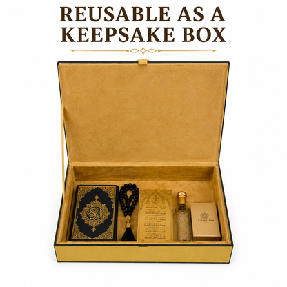 An open keepsake box with a gold interior and black exterior, displayed on a white background with the text 'REUSABLE AS A KEEPSAKE BOX' above it. Inside are a black and gold book, a black prayer bead necklace, a gold card, a small bottle, and a small gold box.