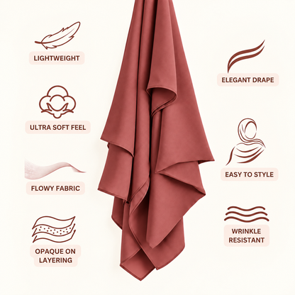 A dusty rose pink draped fabric, likely a hijab or scarf, shown against a light cream background with feature callouts and icons for lightweight, elegant drape, ultra soft feel, flowy fabric, easy to style, opaque on layering, and wrinkle resistant.