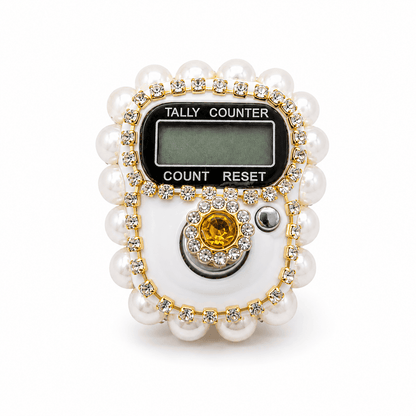 Tally counter with pearl-like casing and gemstone on a white background