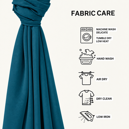 A teal fabric curtain panel is shown on the left with a gathered top and flowing drape, next to a 'FABRIC CARE' infographic on a light beige background. The infographic lists care instructions with icons: machine wash delicate, hand wash, air dry, dry clean, and low iron.